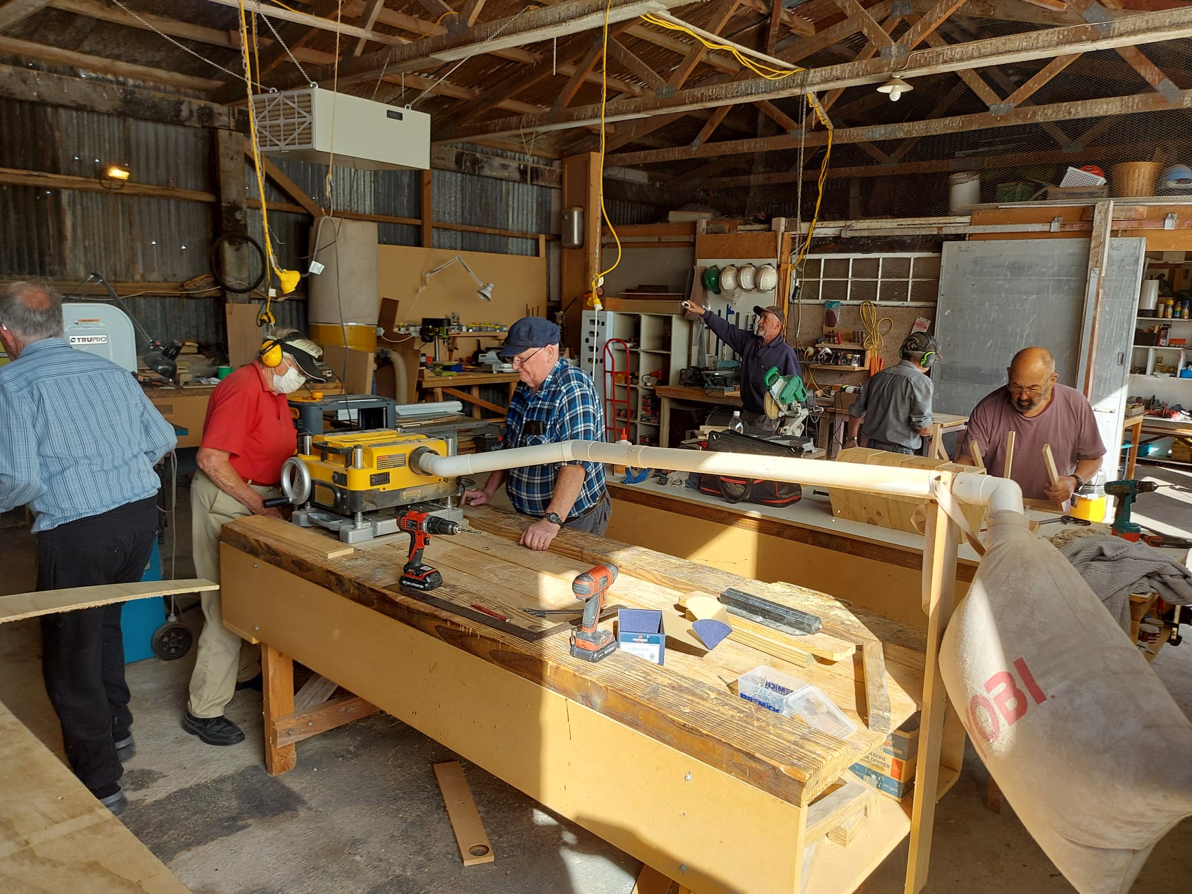 Amberley Menz Shed members working together in the workshop